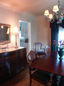 Elegant formal dining room with coved ceiling and hardwood floors.