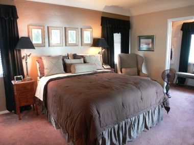 View of master bedroom suite with walk-in closet to the right and private half bath to the left.