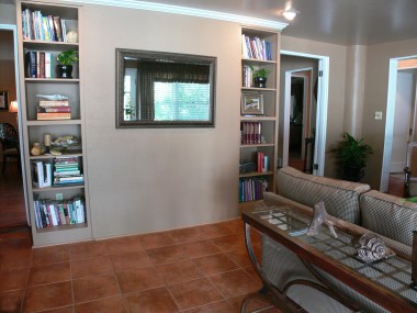 View of bookshelves in family room (living room fireplace is behind this wall).