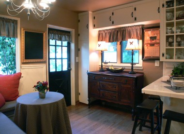 Alternate view of kitchen with breakfast bar to the right, lots of cabinetry, and nook to the left.