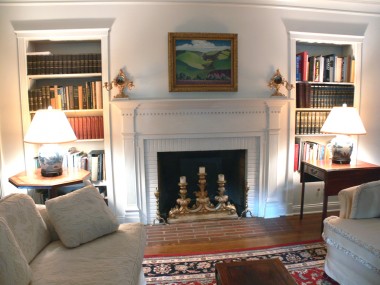 Elegant fireplace flanked by built-in bookshelves. Imagine yourself in front of a crackling fire with a hot toddy in one hand and a good book in the other!