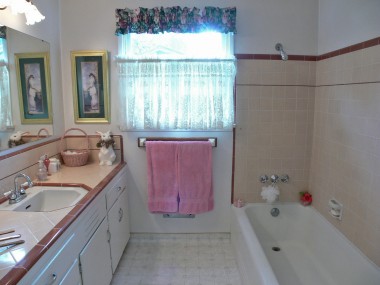 Hallway bathroom with original 50's tile in great condition. Current homeowners don't use this shower, so they've removed the shower curtain for aesthetic reasons. A curtain can easily be put back in place.