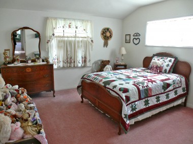 Spacious secondary bedroom with smaller walk-in closet. Note the unique shaped ceiling.