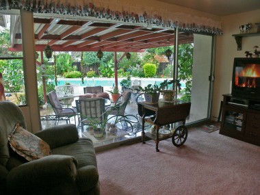 Family room overlooking covered patio and pool.
