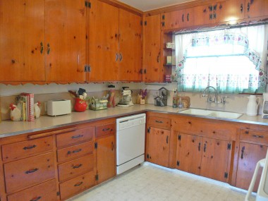 Gorgeous original knotty pine cabinetry in kitchen.