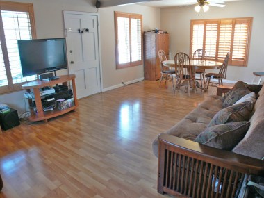 Large living room and dining room with Pergo flooring, double paned windows and wood window shutters! 4494 Elmwood Ct., Riverside