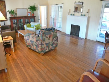 Spacious living room with original hardwood floors and French doors flanking the fireplace. 4459 Oakwood Pl., Riverside